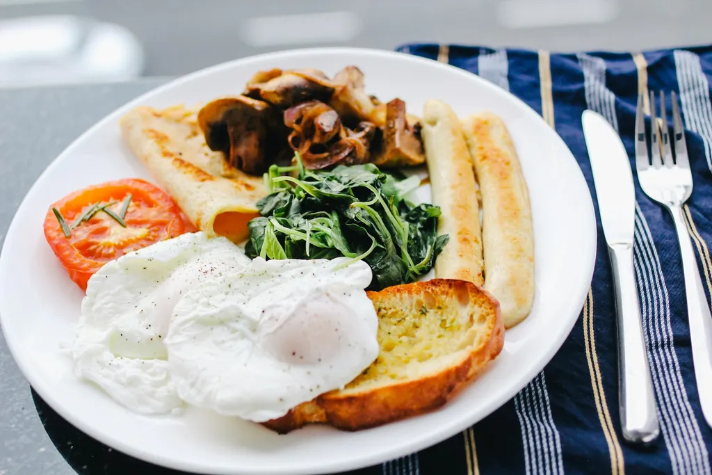 A sunny side up egg on a white ceramic plate