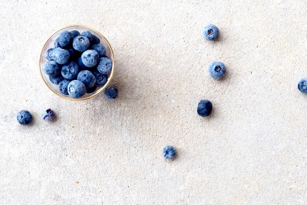 Fresh blueberries in a clear glass bowl