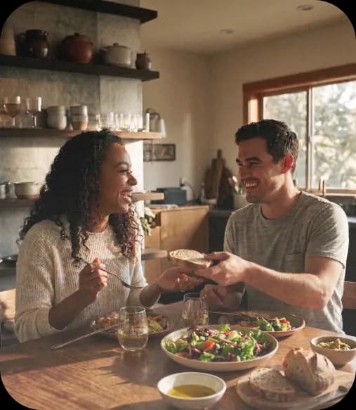 Two people sharing a fresh, healthy meal at a kitchen table